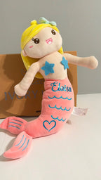 Personalized blonde mermaid plush doll with a pink tail, custom stamped for a unique baby gift.