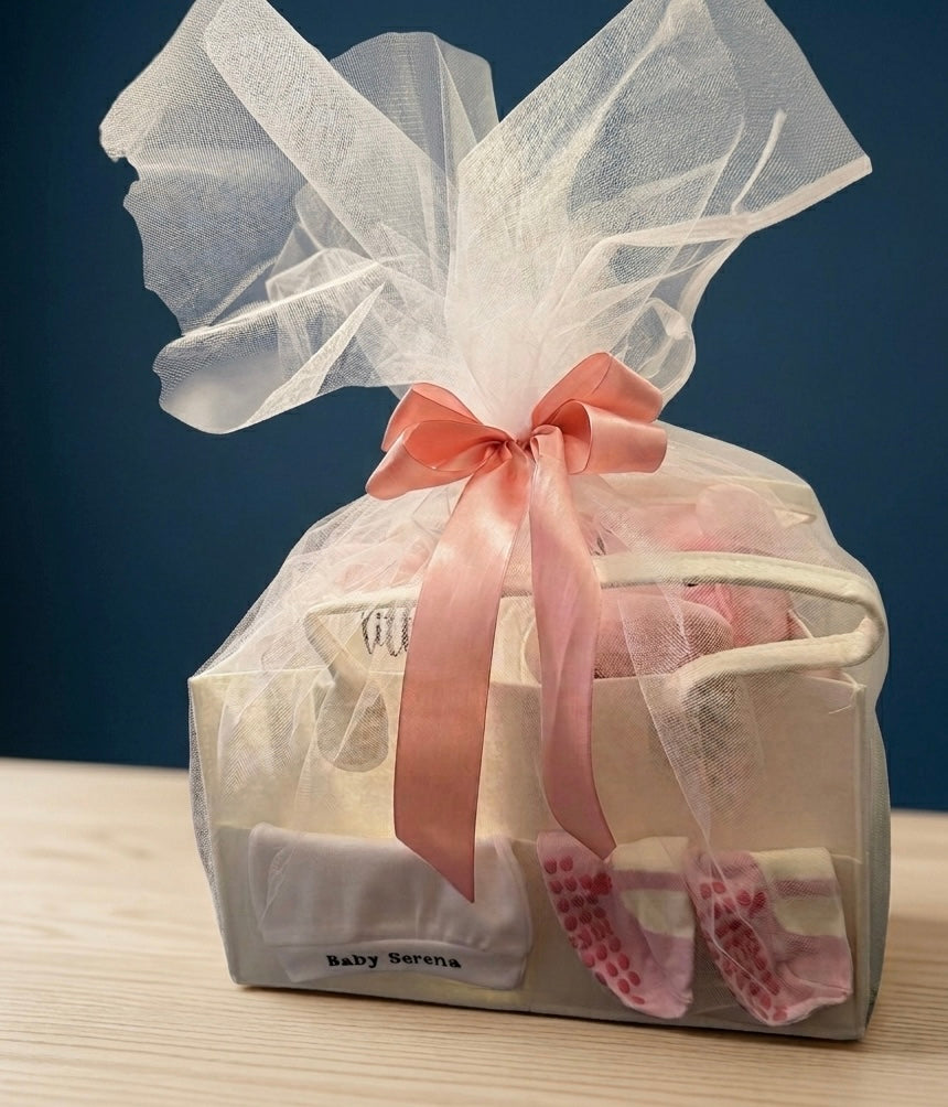 Ivory Heir signature luxury packaging for newborn gift sets, wrapped elegantly in tulle with a premium pink ribbon bow.