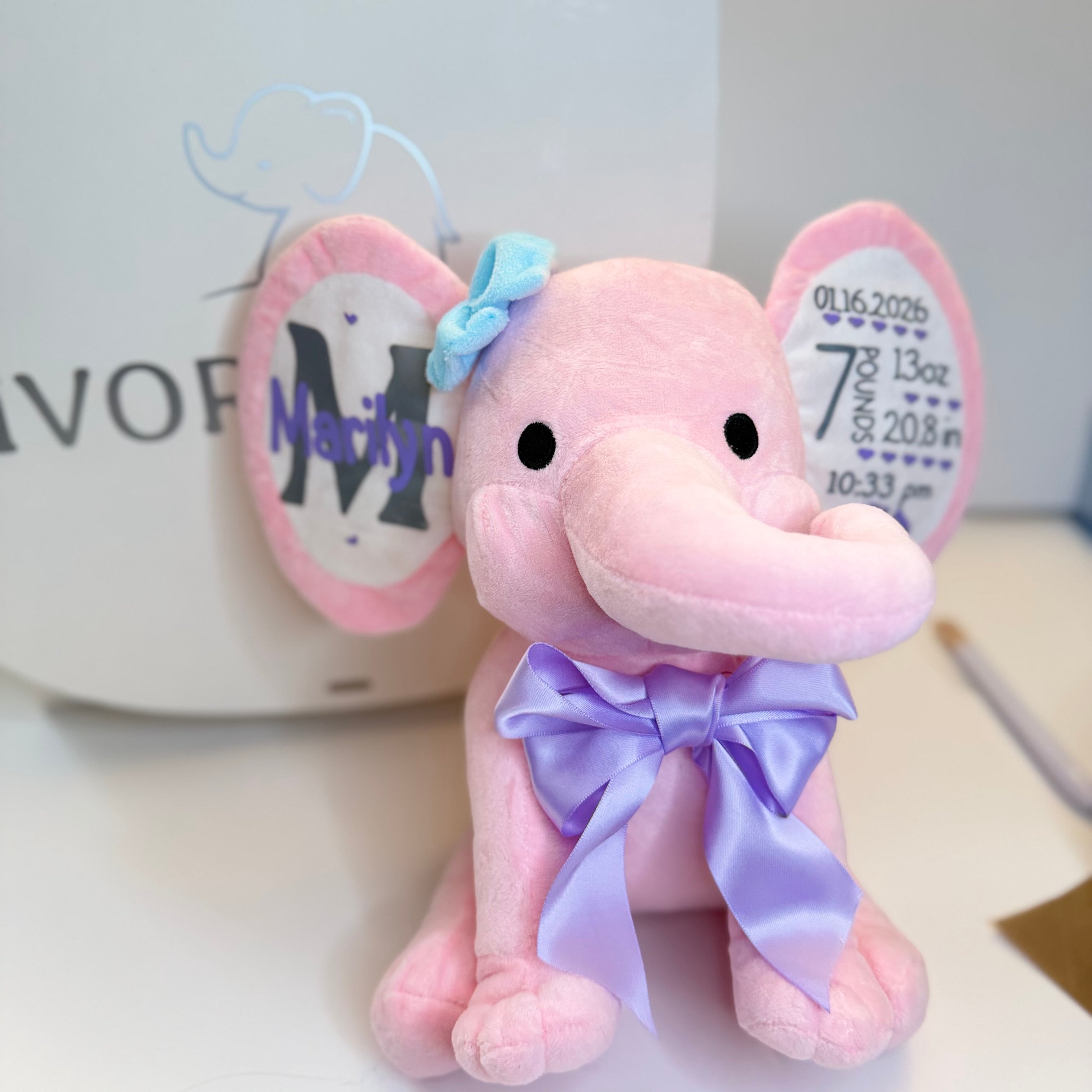 Ivory Heir personalized birth stats plush elephant in pink with customized name and baby birth details stamped on the ears.