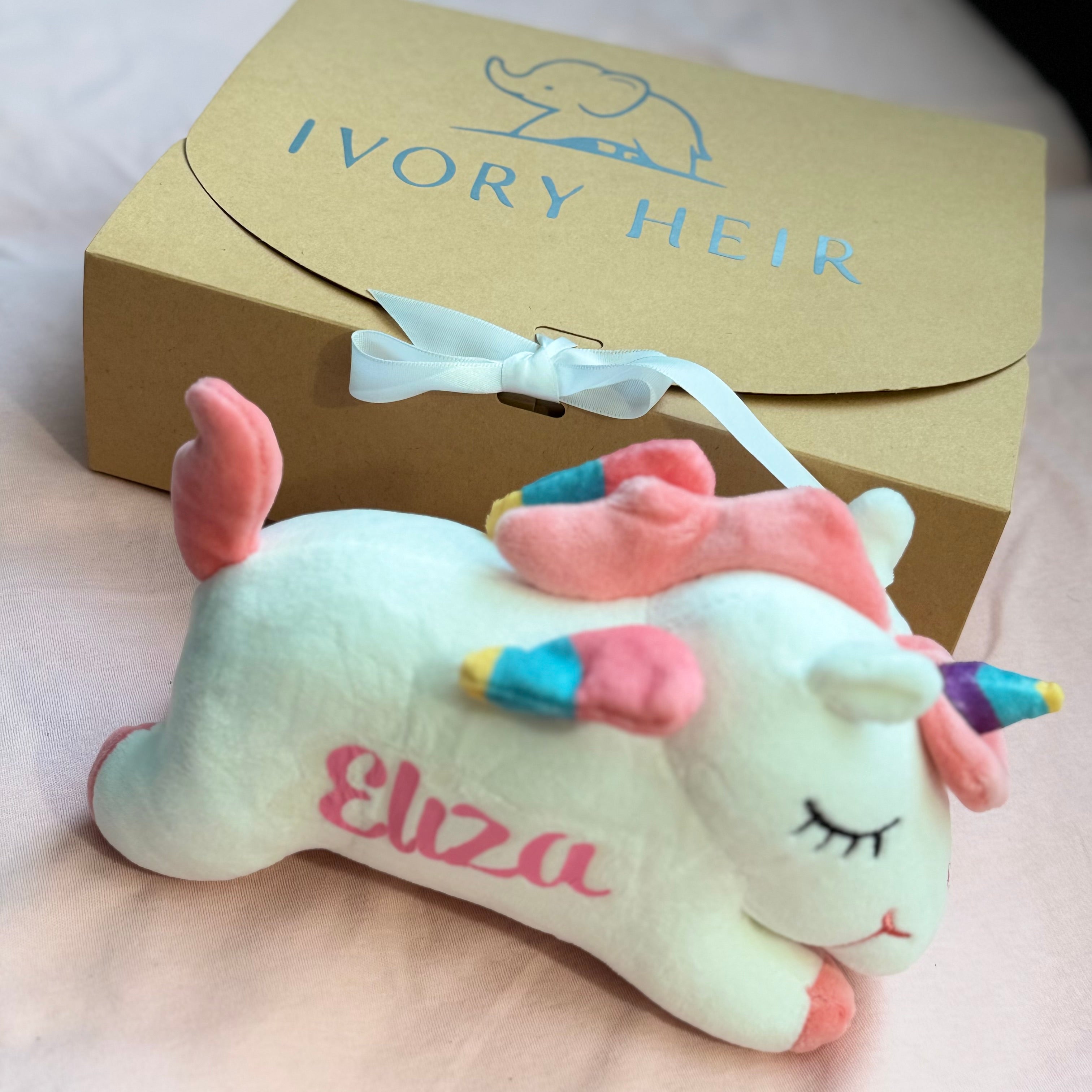 Ivory Heir personalized unicorn plush toy in mint with pink hair, custom stamped with the name Eliza.